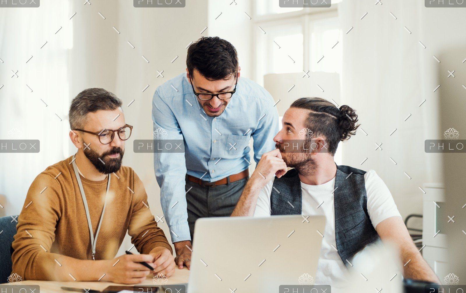 demo-attachment-505-group-of-young-businesspeople-with-laptop-working-8SHTZUN